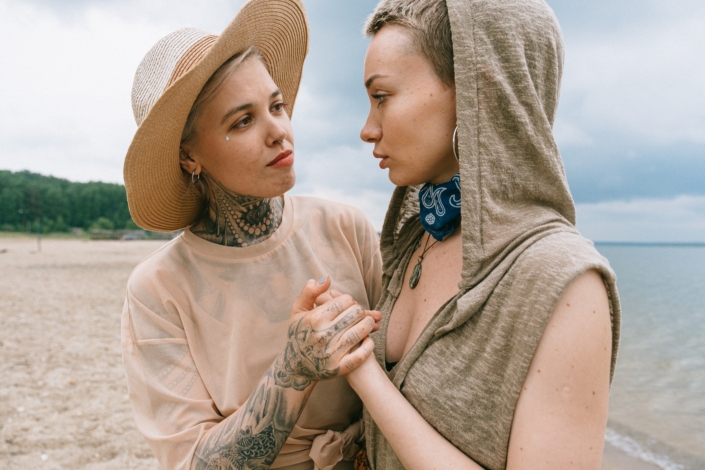 LGBTQ-affirming couple embracing hands in comfort